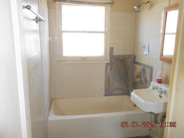 bathroom featuring shower / bath combination and a sink