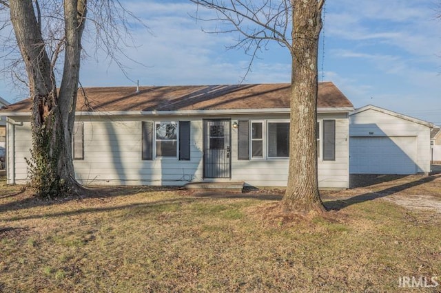 ranch-style home with a garage and a front lawn