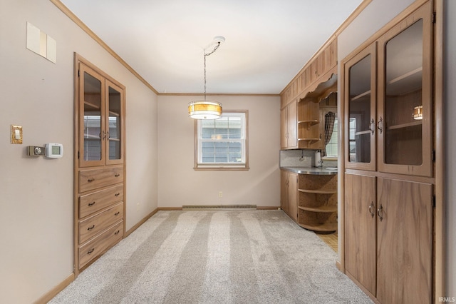 interior space with light carpet, baseboards, ornamental molding, glass insert cabinets, and open shelves