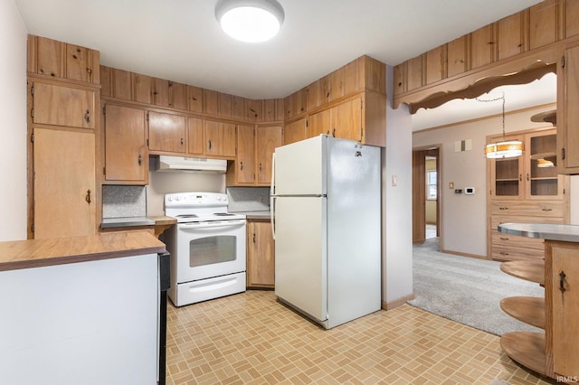 kitchen featuring brick floor, tasteful backsplash, light countertops, white appliances, and under cabinet range hood