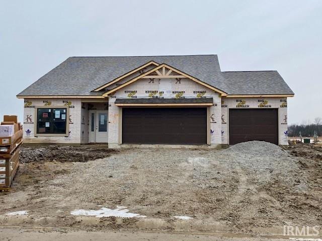 property in mid-construction with driveway and a garage