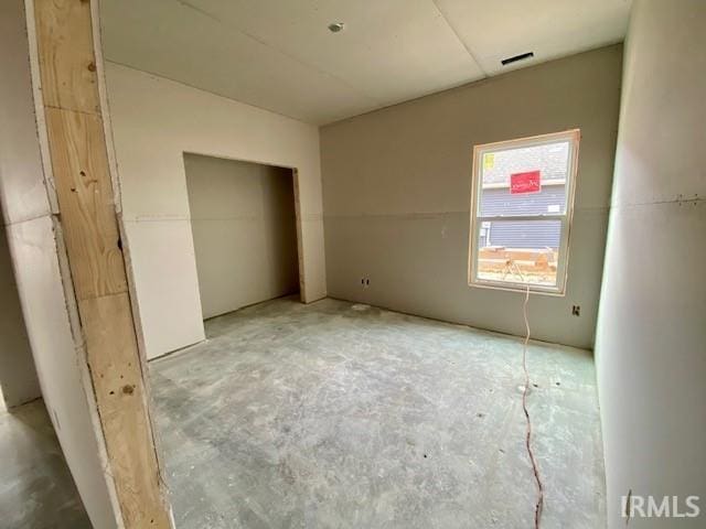 unfurnished bedroom with visible vents and a closet