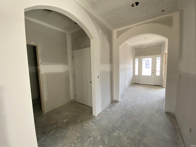 corridor featuring a textured ceiling