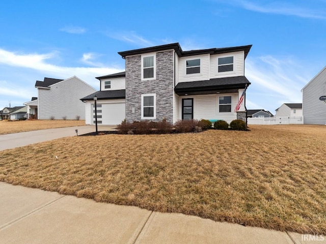 view of front of house featuring a garage, stone siding, a front lawn, and driveway