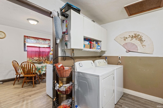 laundry room featuring laundry area, separate washer and dryer, baseboards, light wood-style floors, and attic access