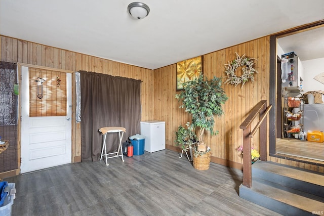 empty room with wooden walls and wood finished floors