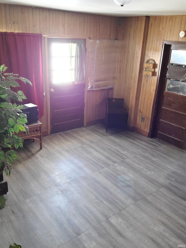 foyer featuring wood walls