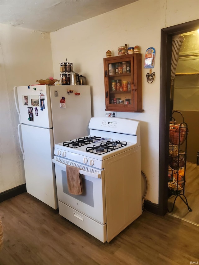 kitchen with white appliances and wood finished floors