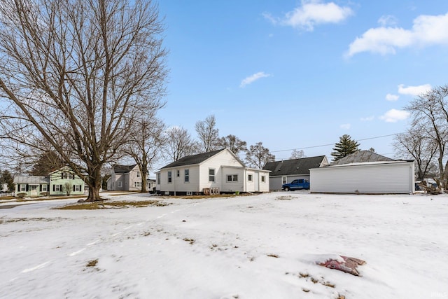 view of snow covered exterior with a garage