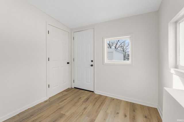 interior space featuring baseboards and light wood-style floors