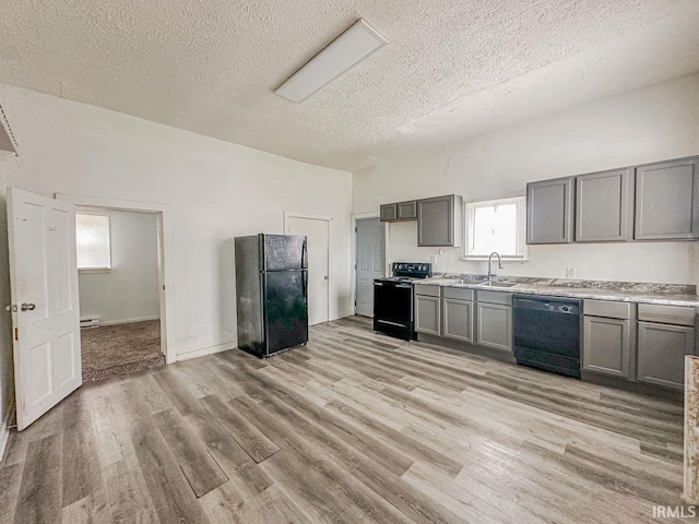 233 W 4th St, Greensburg, IN 47240 - kitchen featuring black appliances, light wood finished floors, a sink, and gray cabinetry