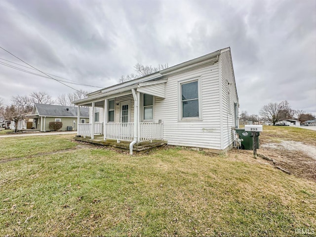 233 W 4th St, Greensburg, IN 47240 - view of front facade featuring a front lawn and a porch