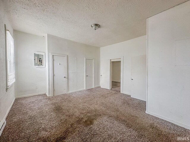 233 W 4th St, Greensburg, IN 47240 - unfurnished bedroom featuring electric panel, carpet flooring, and a textured ceiling