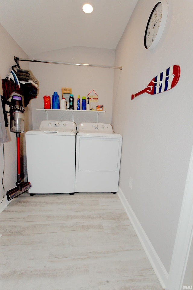 clothes washing area featuring laundry area, baseboards, wood finished floors, washing machine and clothes dryer, and recessed lighting