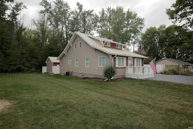 view of front of home with central AC unit and a front lawn