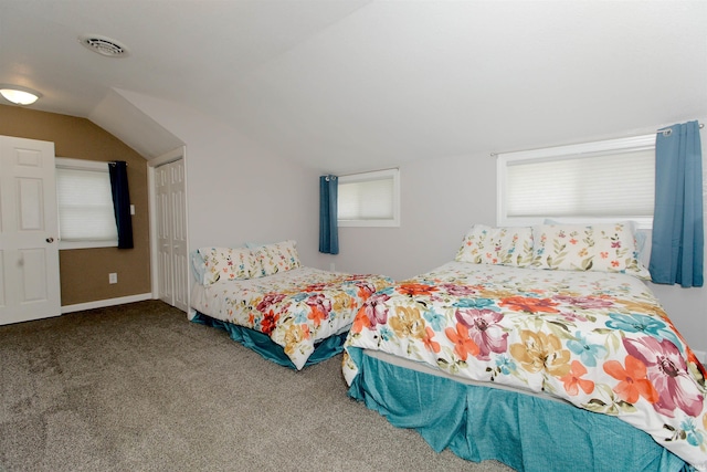 carpeted bedroom with lofted ceiling, baseboards, multiple windows, and visible vents