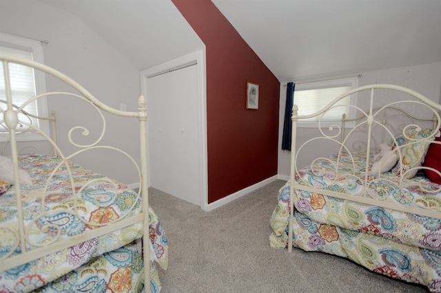 bedroom featuring carpet flooring and vaulted ceiling