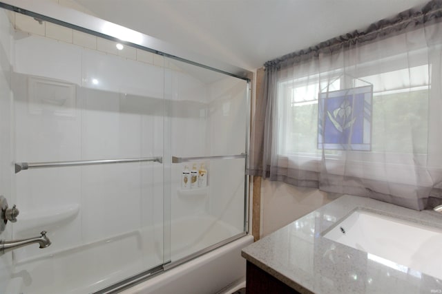 full bathroom with enclosed tub / shower combo and vanity