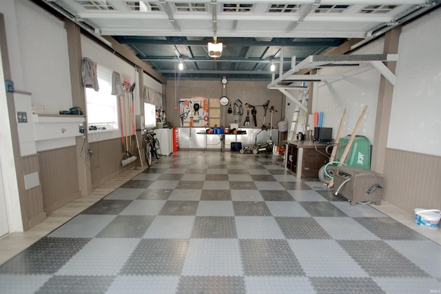 garage with a wainscoted wall and a garage door opener