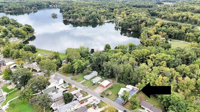 aerial view featuring a forest view and a water view