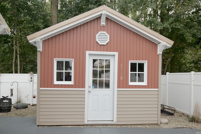 view of outbuilding with an outbuilding and fence