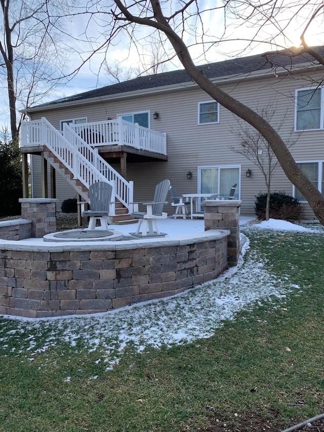 back of property with stairway, a patio area, and a wooden deck