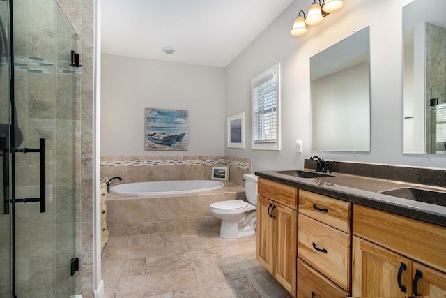 full bathroom featuring double vanity, toilet, a sink, a shower stall, and a bath