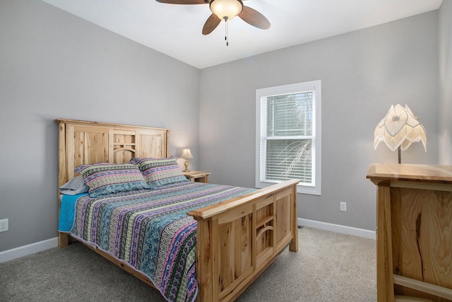 bedroom featuring a ceiling fan, light carpet, and baseboards