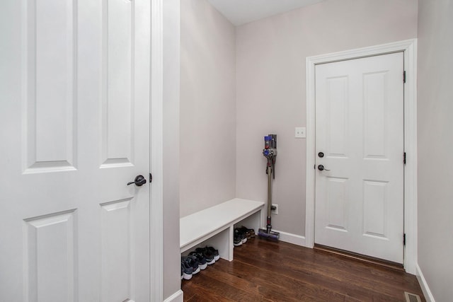 mudroom with dark wood-type flooring, visible vents, and baseboards