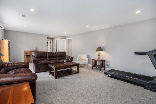 carpeted living room featuring baseboards, visible vents, and recessed lighting