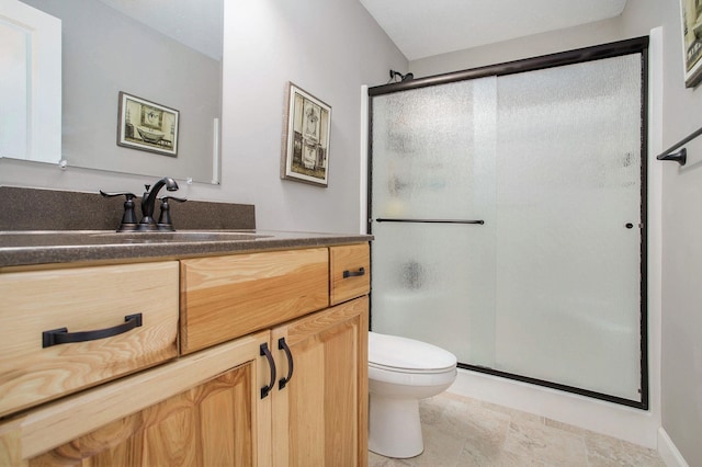 full bath featuring a stall shower, vanity, and toilet