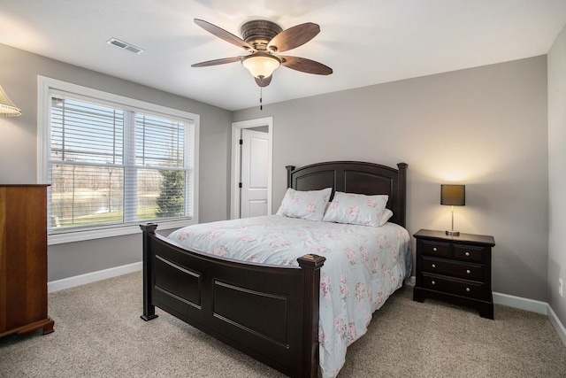 bedroom featuring light carpet, baseboards, visible vents, and a ceiling fan