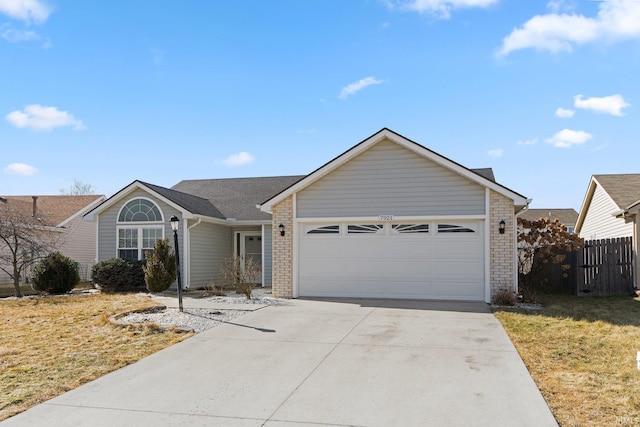 ranch-style house with brick siding, concrete driveway, a front yard, fence, and a garage