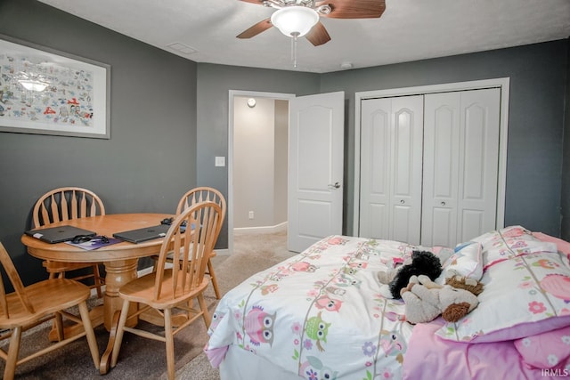 bedroom with light colored carpet, visible vents, baseboards, a ceiling fan, and a closet