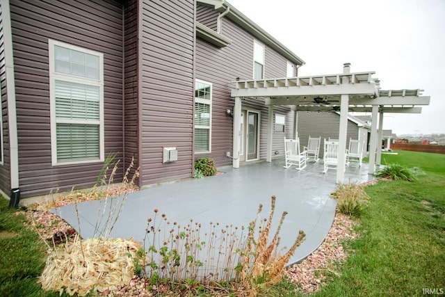 back of house with a patio, a lawn, and a pergola