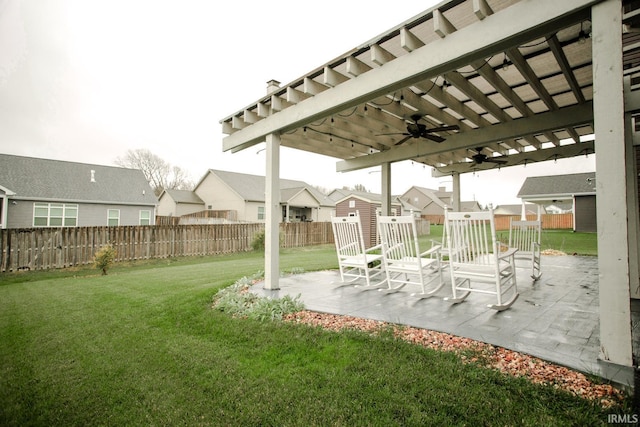 view of yard featuring a residential view, fence, a ceiling fan, and a patio