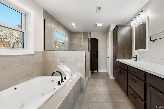 bathroom featuring recessed lighting, vanity, visible vents, a tile shower, and a whirlpool tub