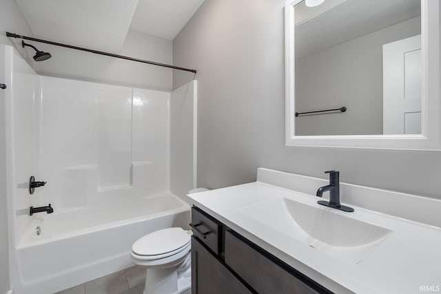 full bathroom featuring tile patterned flooring, bathing tub / shower combination, vanity, and toilet