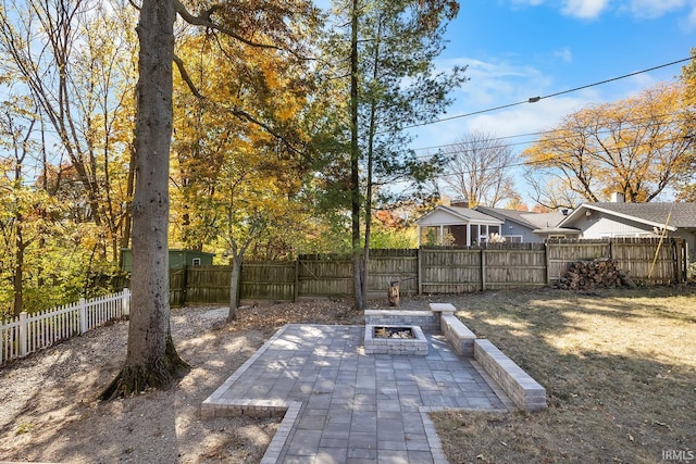 view of yard with a fire pit, a patio area, and a fenced backyard