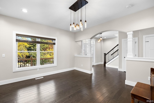 interior space featuring stairway, visible vents, baseboards, and wood finished floors