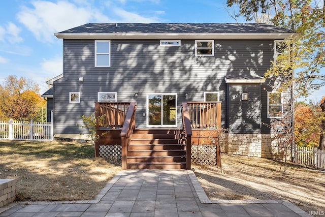 back of house with a deck, stairway, and fence