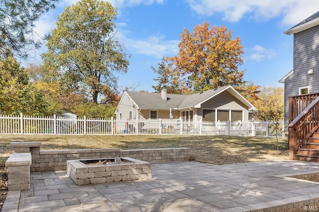 back of house with a patio, an outdoor fire pit, a chimney, and fence private yard