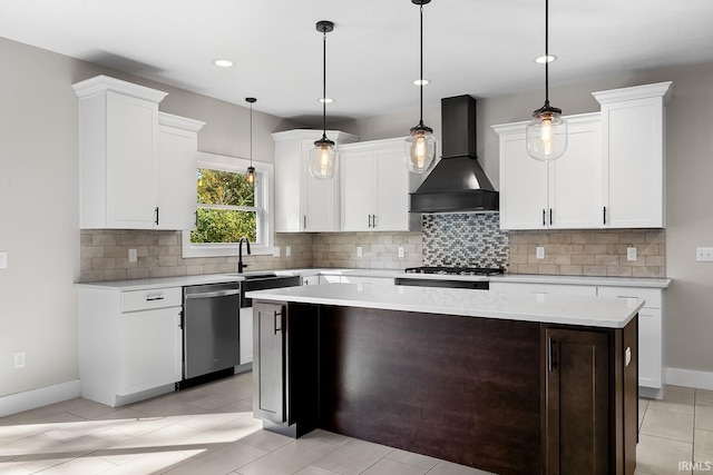 kitchen featuring wall chimney range hood, backsplash, light countertops, and dishwasher