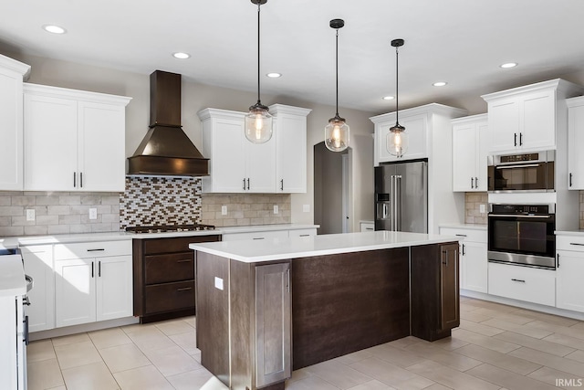 kitchen featuring high end refrigerator, a center island, light countertops, premium range hood, and white cabinetry