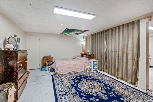 bedroom featuring a textured ceiling and unfinished concrete floors