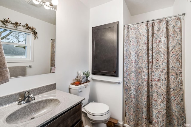 full bathroom featuring curtained shower, vanity, and toilet