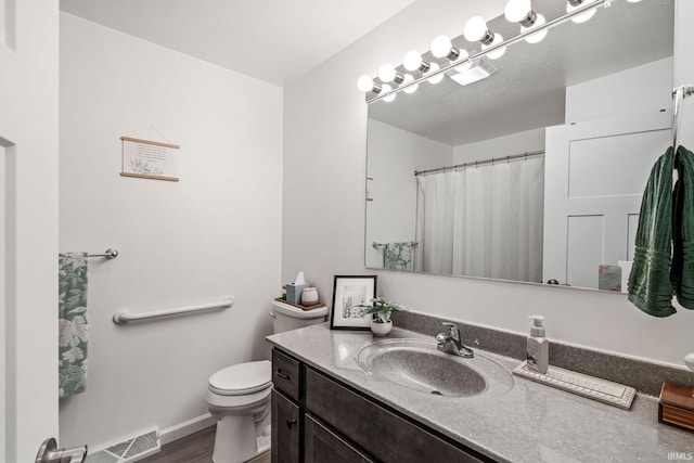 bathroom featuring curtained shower, toilet, wood finished floors, vanity, and baseboards