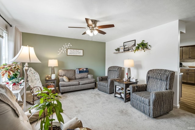 living room with ceiling fan and light colored carpet