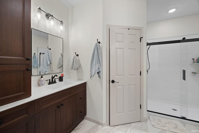 full bath with a stall shower, marble finish floor, and vanity