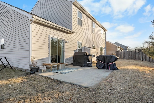 back of house featuring a patio, a yard, and fence